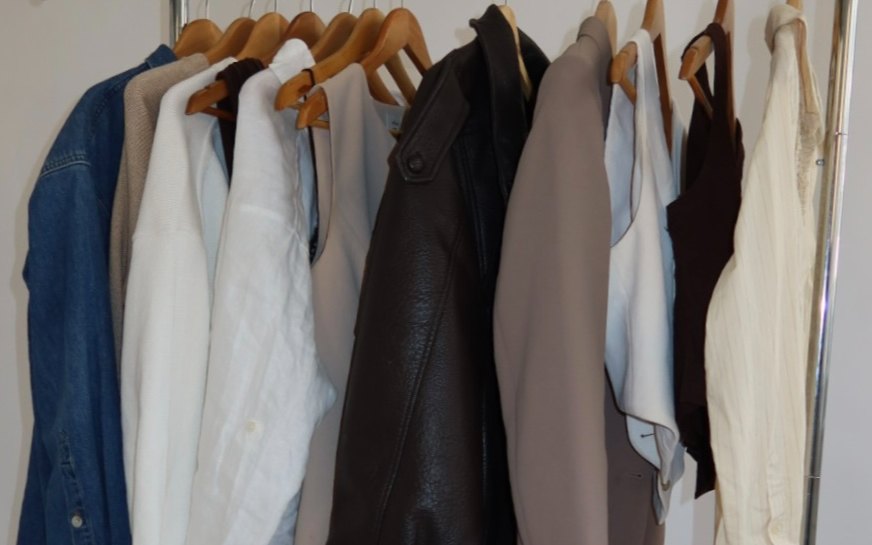 A rail of pre-loved coats, shirts and knitwear